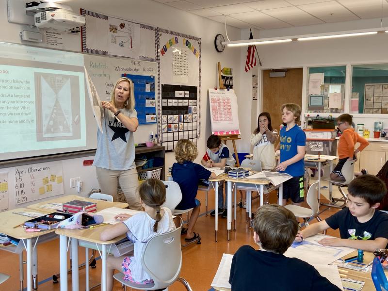 Rehoboth Toy & Kite co-owner Rachel Webster teaches students about the history of kites and how to make the flying contraptions with materials she provided.